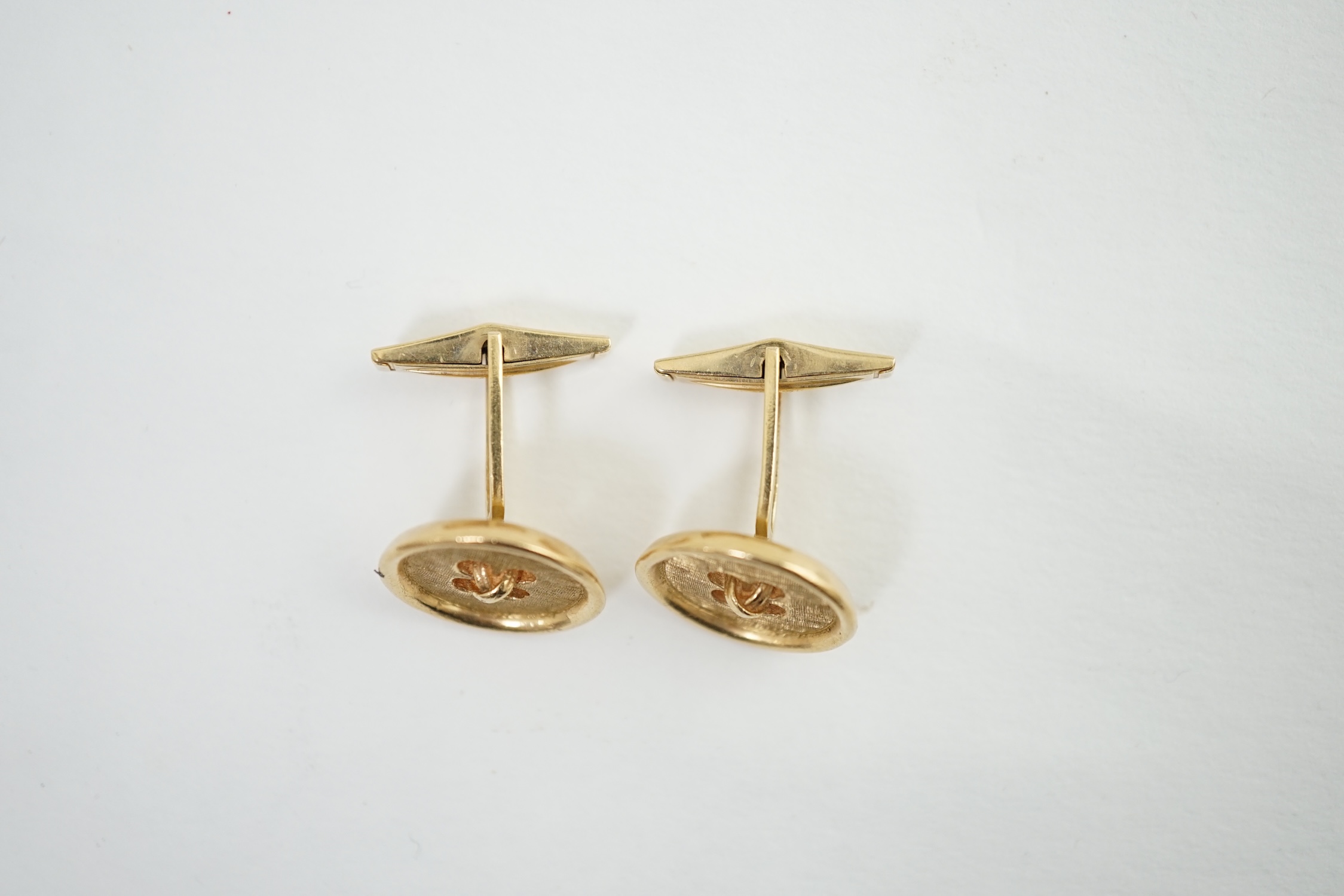 A pair of 14K yellow gold button design cufflinks, by Merrin & Co